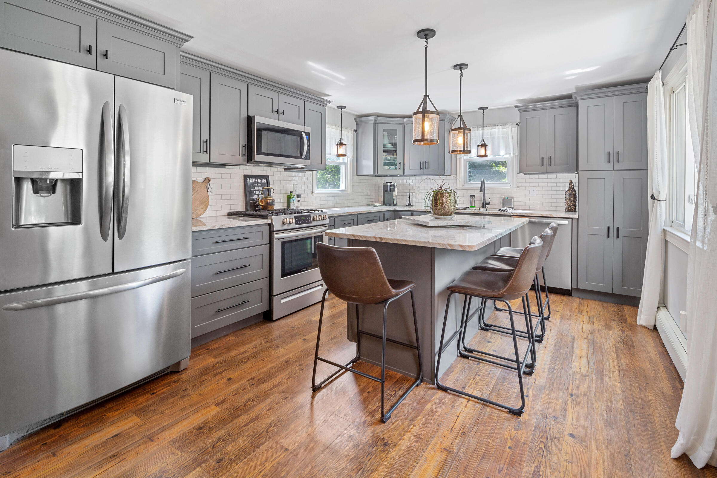 31 Soundview Road Centerville, MA 02632 - Photo 6 of 50 a kitchen with stainless steel appliances a dining table a stove a refrigerator a sink a dining table and chairs