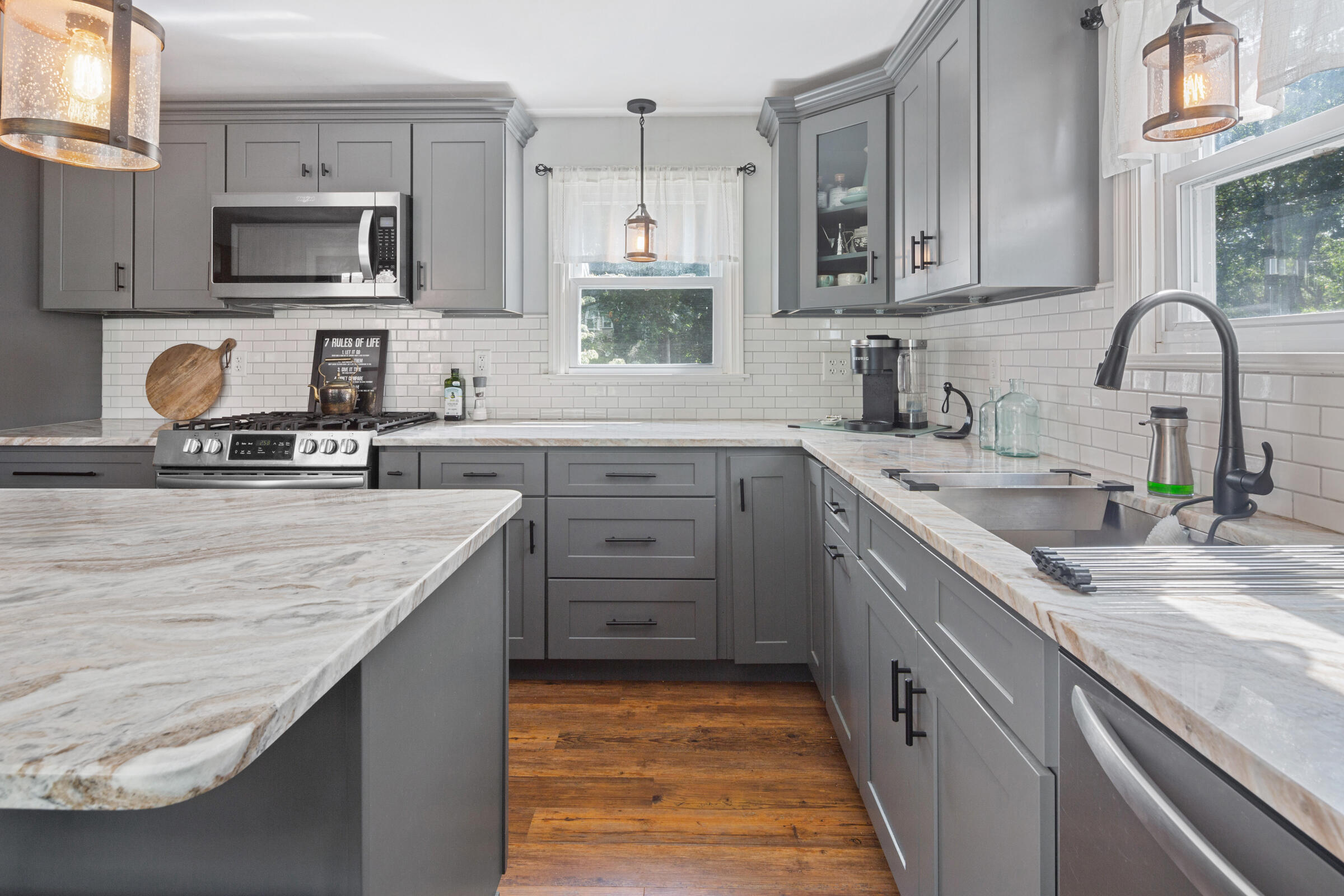 31 Soundview Road Centerville, MA 02632 - Photo 9 of 50 a kitchen with stainless steel appliances granite countertop a sink stove microwave and refrigerator