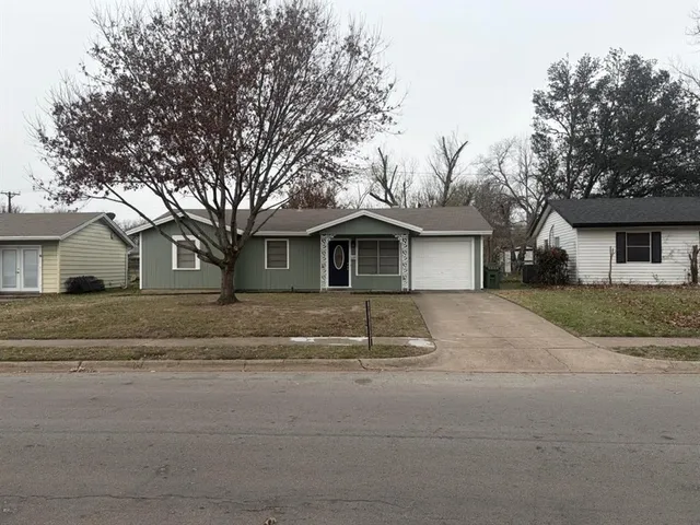 a front view of a house with a road