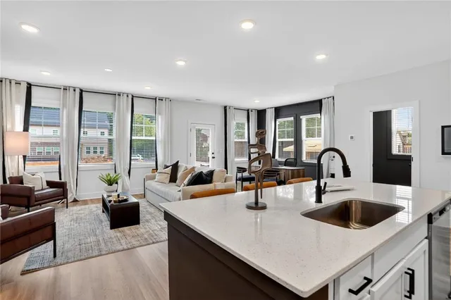 a living room with furniture kitchen and a table