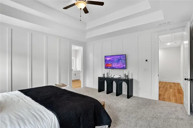 a view of kitchen with white wooden cabinets and wooden floor