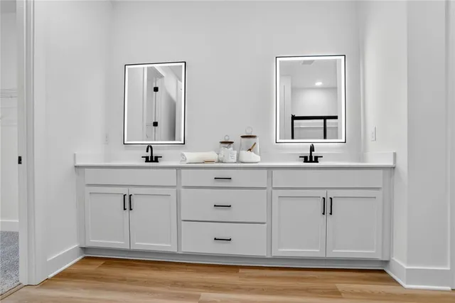 a bedroom with a bed and large windows