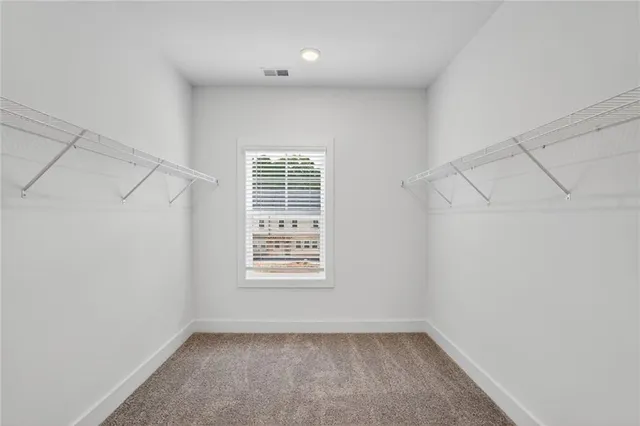 a bedroom with a bed and a lamp