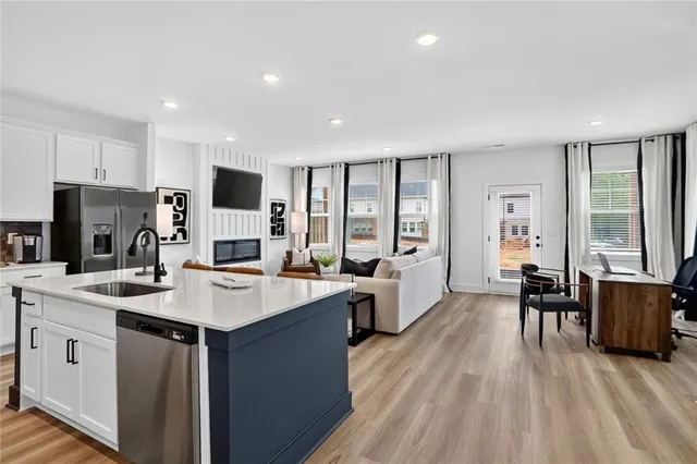 a living room with furniture a fireplace and a flat screen tv