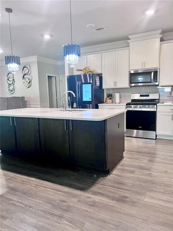 3370 Elkhorn Ridge Run Dacula, GA 30019 - Photo 6 of 29 a kitchen with stainless steel appliances granite countertop a sink a stove top oven a counter space and cabinets