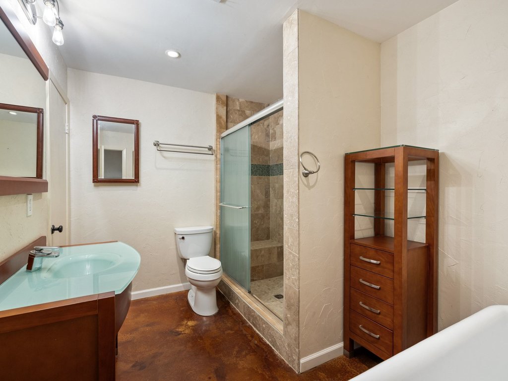 4711 Fieldstone Drive Austin, TX 78735 - Photo 13 of 40 a bathroom with a toilet a sink and shower