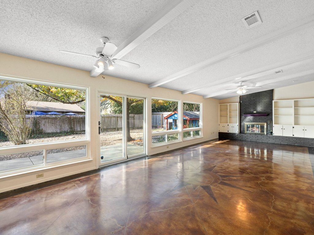 4711 Fieldstone Drive Austin, TX 78735 - Photo 5 of 40 a view of an empty room with wooden floor and a window