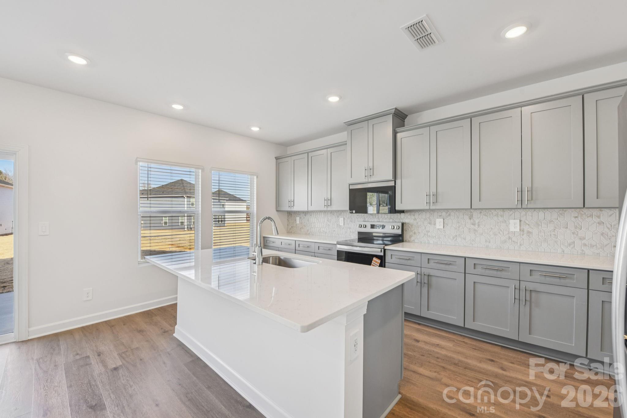 178 Murphy Mdw Road Mocksville, NC 27028 - Photo 2 of 22 a kitchen with a sink cabinets and wooden floor
