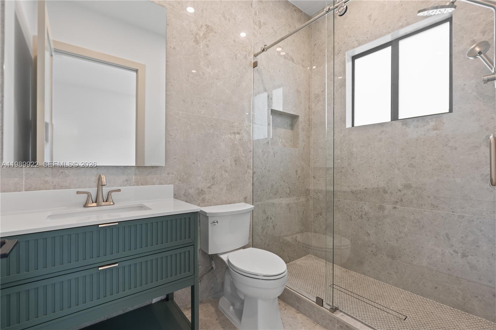 6221 Southwest 60th Street South Miami, FL 33143 - Photo 33 of 42 a bathroom with a sink toilet a mirror and shower