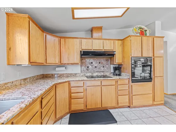 a kitchen with granite countertop a stove a sink and a granite counter tops