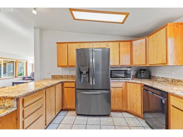 a kitchen with stainless steel appliances granite countertop a refrigerator sink and cabinets