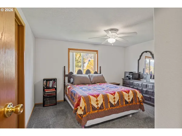 a bedroom with a bed and a dresser in it