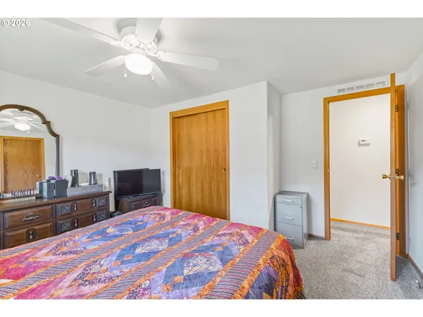 a bedroom with a bed and a dresser