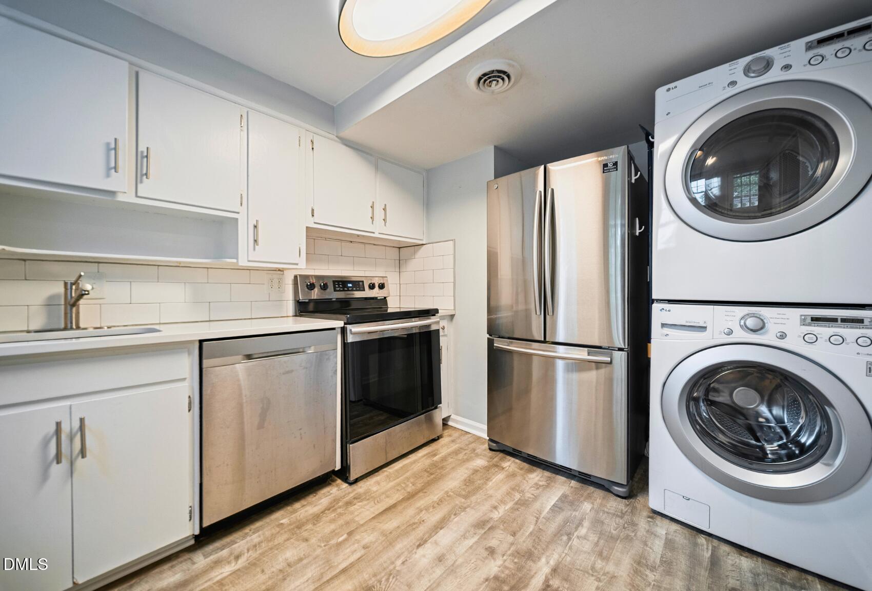 967 St Marys Street Raleigh, NC 27605 - Photo 16 of 34 a kitchen with a refrigerator sink and cabinets