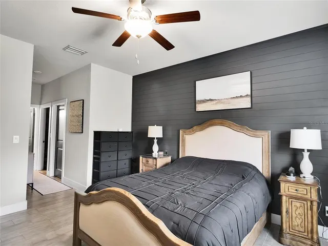 a bedroom with a large bed and a lamp