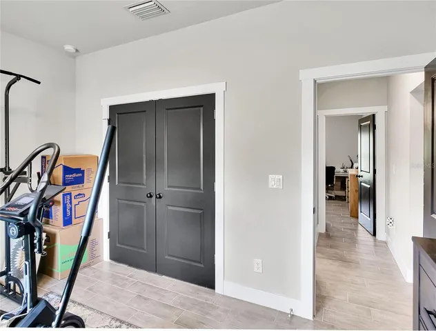 a view of a hallway with wooden floor and entryway
