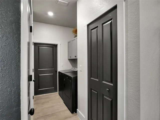 a kitchen with a refrigerator and cabinets
