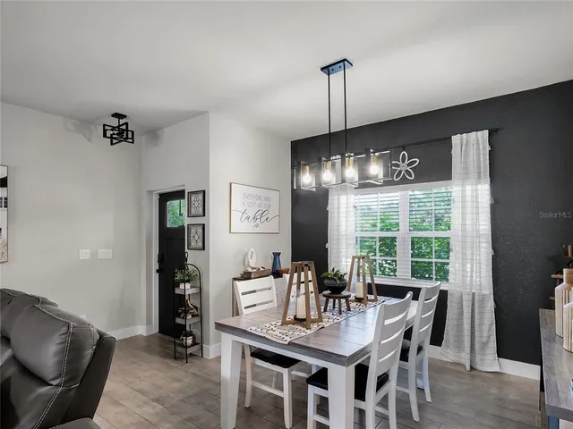 a view of a dining room with furniture window and outside view