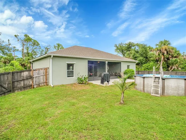 a house view with swimming pool in front of it