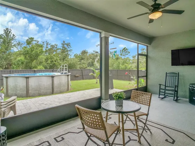 a balcony with furniture and a floor to ceiling window