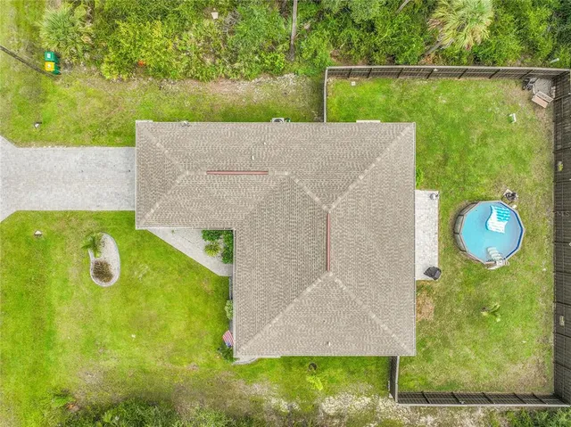 a view of a house with a backyard