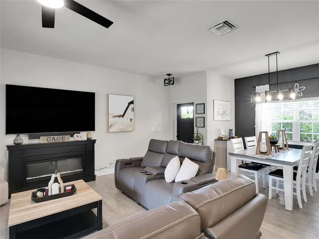 a living room with furniture fireplace and flat screen tv
