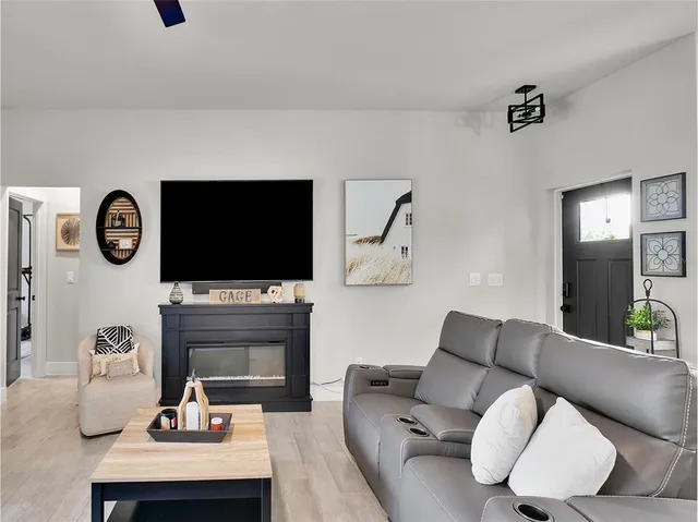 a living room with fireplace furniture and a flat screen tv