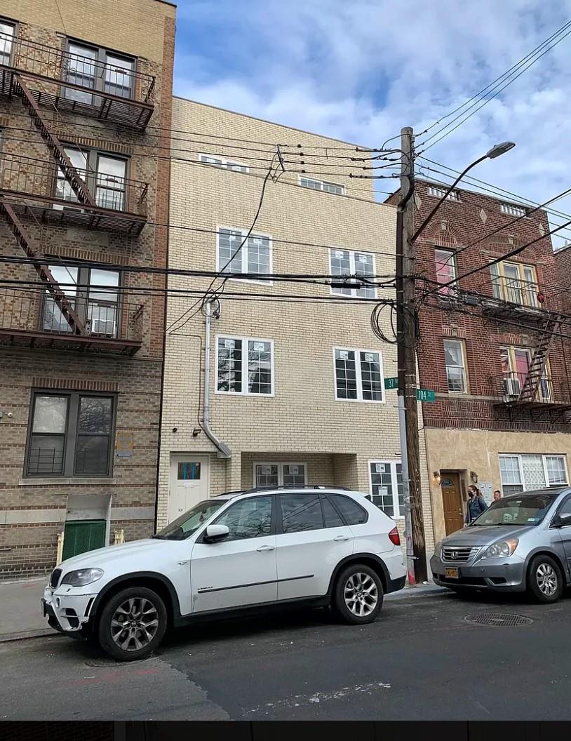 37-28 104th Street Queens, NY 11368 - Photo 2 of 11 a front view of a house with parking space