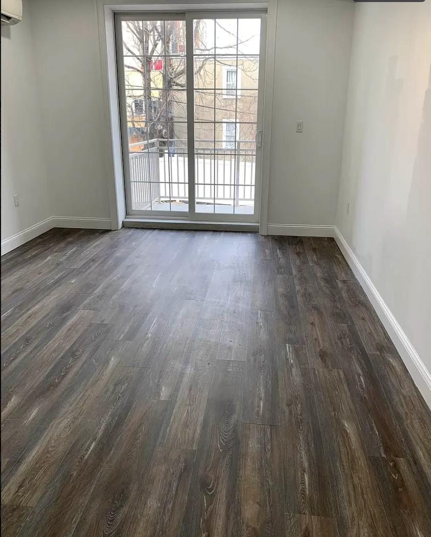 37-28 104th Street Queens, NY 11368 - Photo 6 of 11 wooden floor in an empty room with a window