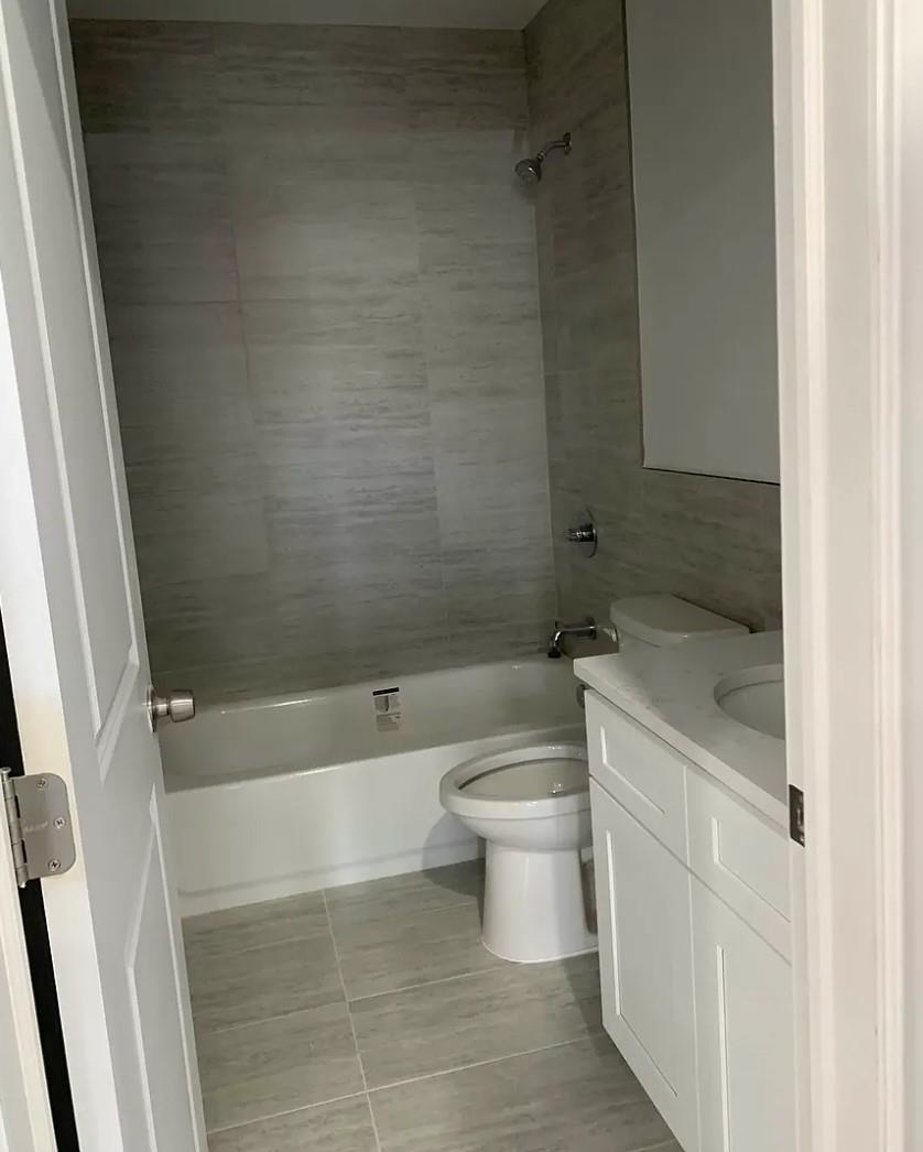 37-28 104th Street Queens, NY 11368 - Photo 8 of 11 a bathroom with a bathtub and toilet