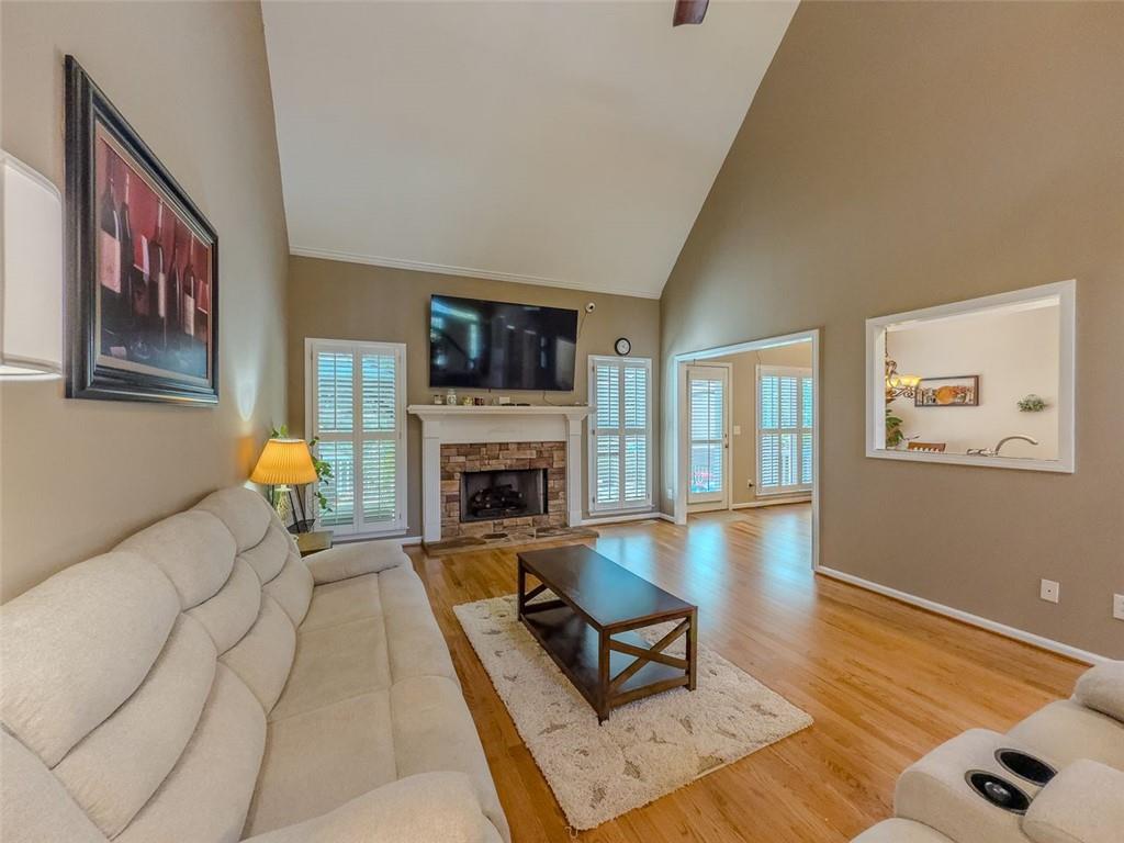 1739 Praters Point Dacula, GA 30019 - Photo 13 of 48 a living room with furniture a flat screen tv and a fireplace