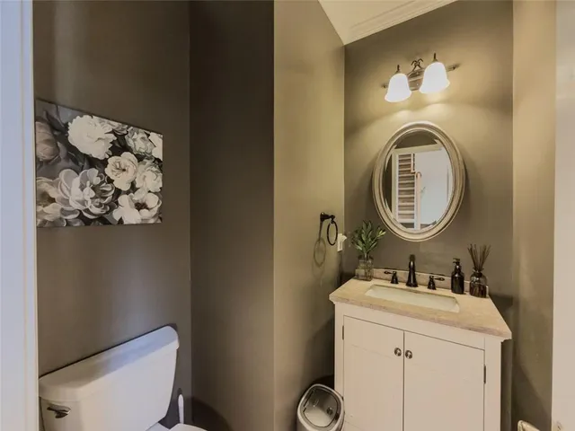 a bathroom with a sink mirror and toilet