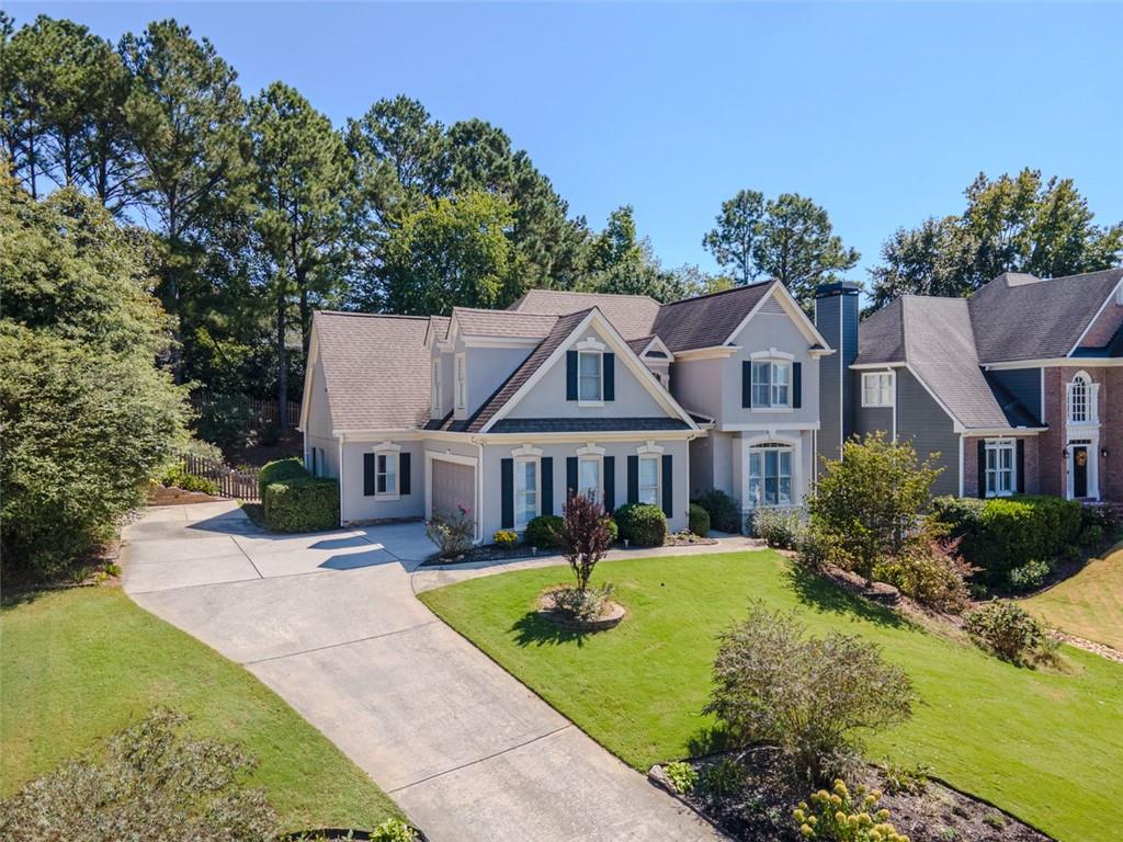 1739 Praters Point Dacula, GA 30019 - Photo 2 of 48 a view of a white house with a big yard and potted plants