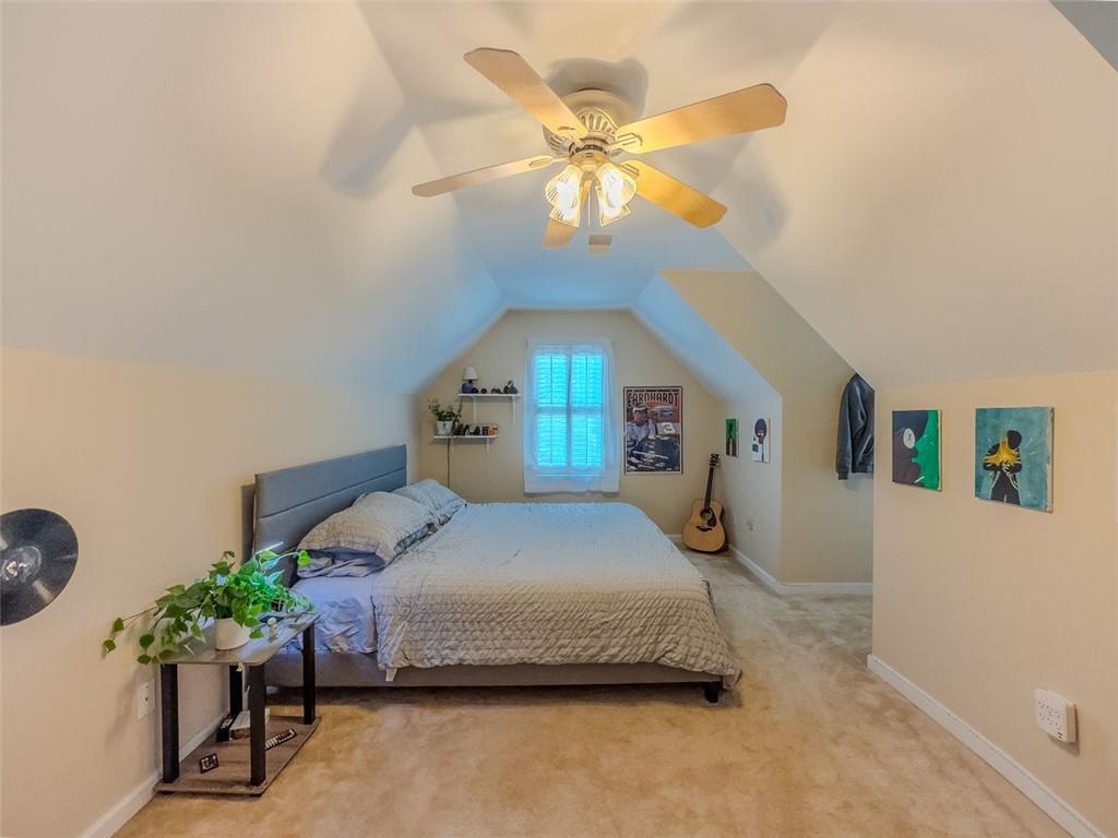 1739 Praters Point Dacula, GA 30019 - Photo 26 of 48 a bedroom with a bed and a chandelier