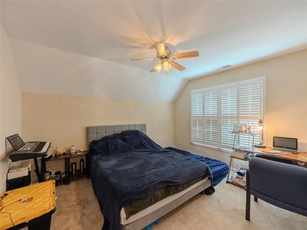 1739 Praters Point Dacula, GA 30019 - Photo 27 of 48 a bedroom with a bed gym equipment and a window