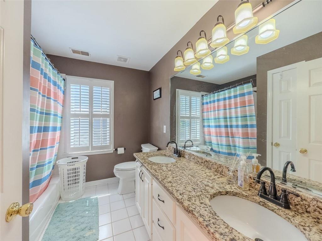 1739 Praters Point Dacula, GA 30019 - Photo 28 of 48 a bathroom with double vanity and a mirror