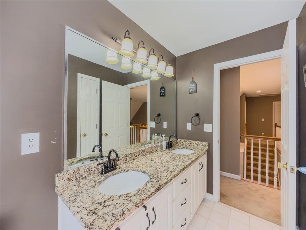 1739 Praters Point Dacula, GA 30019 - Photo 29 of 48 a bathroom with a granite countertop sink and a mirror