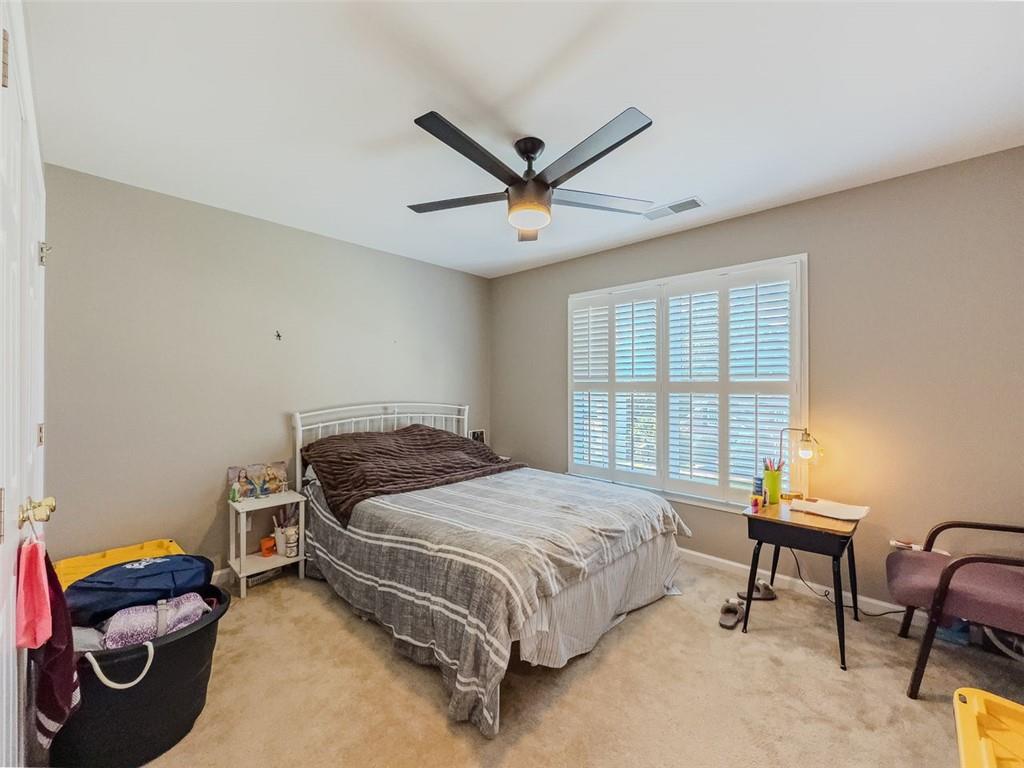 1739 Praters Point Dacula, GA 30019 - Photo 30 of 48 a bedroom with a bed and a window