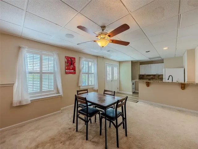 a view of a dining room with furniture and a chandelier