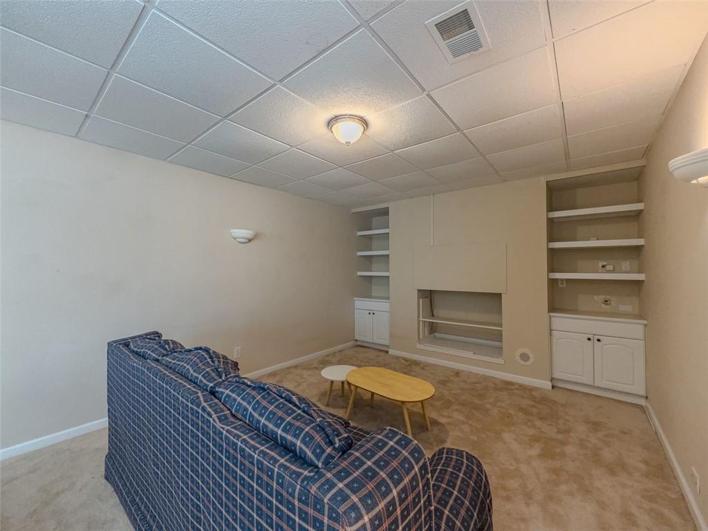 1739 Praters Point Dacula, GA 30019 - Photo 37 of 48 a living room with furniture and a dresser