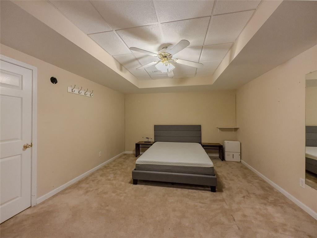 1739 Praters Point Dacula, GA 30019 - Photo 39 of 48 a bedroom with a bed and a chandelier