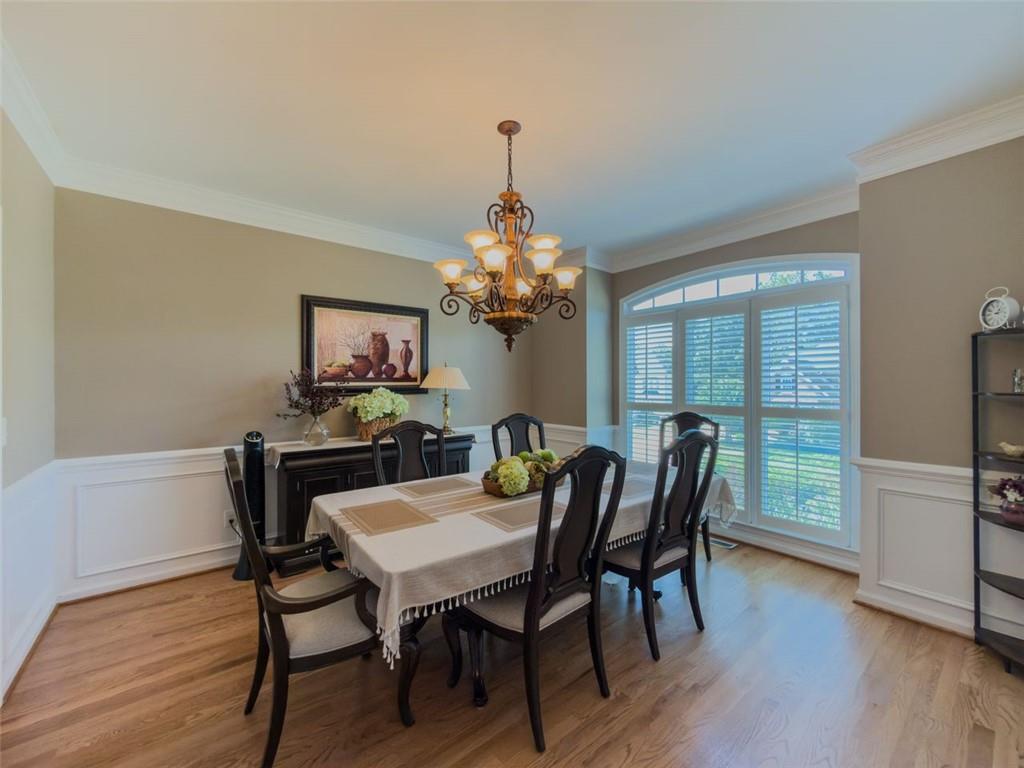 1739 Praters Point Dacula, GA 30019 - Photo 5 of 48 a dining room with furniture a chandelier and wooden floor