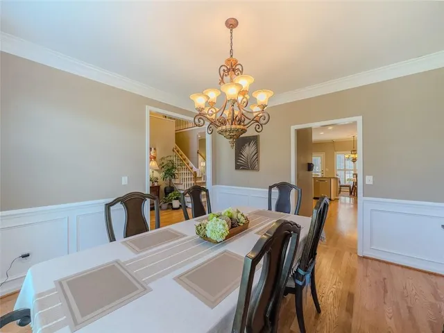 a view of a dining room with furniture and chandelier