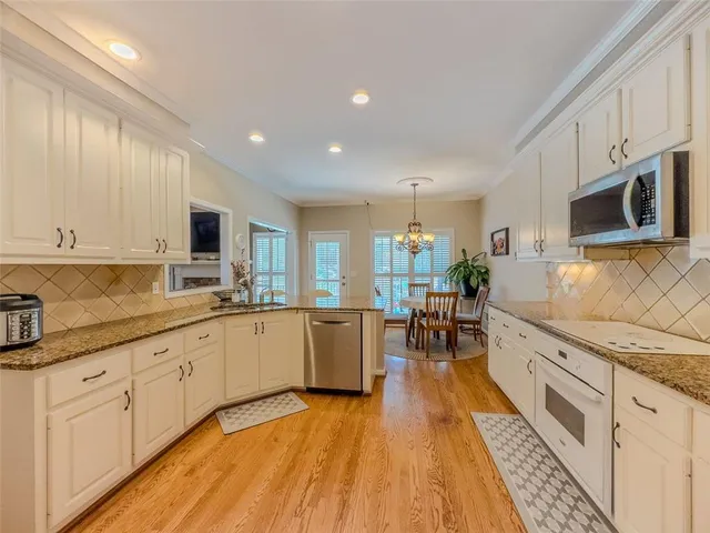 a kitchen with sink cabinets and wooden floor