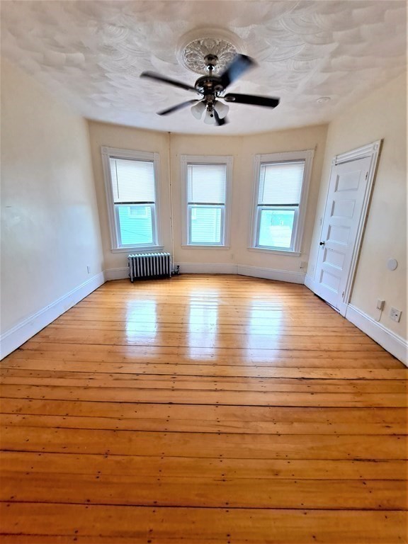 35 Catawba Street, Unit 2 Boston, MA 02119 - Photo 9 of 15 a view of a room with wooden floor and a window