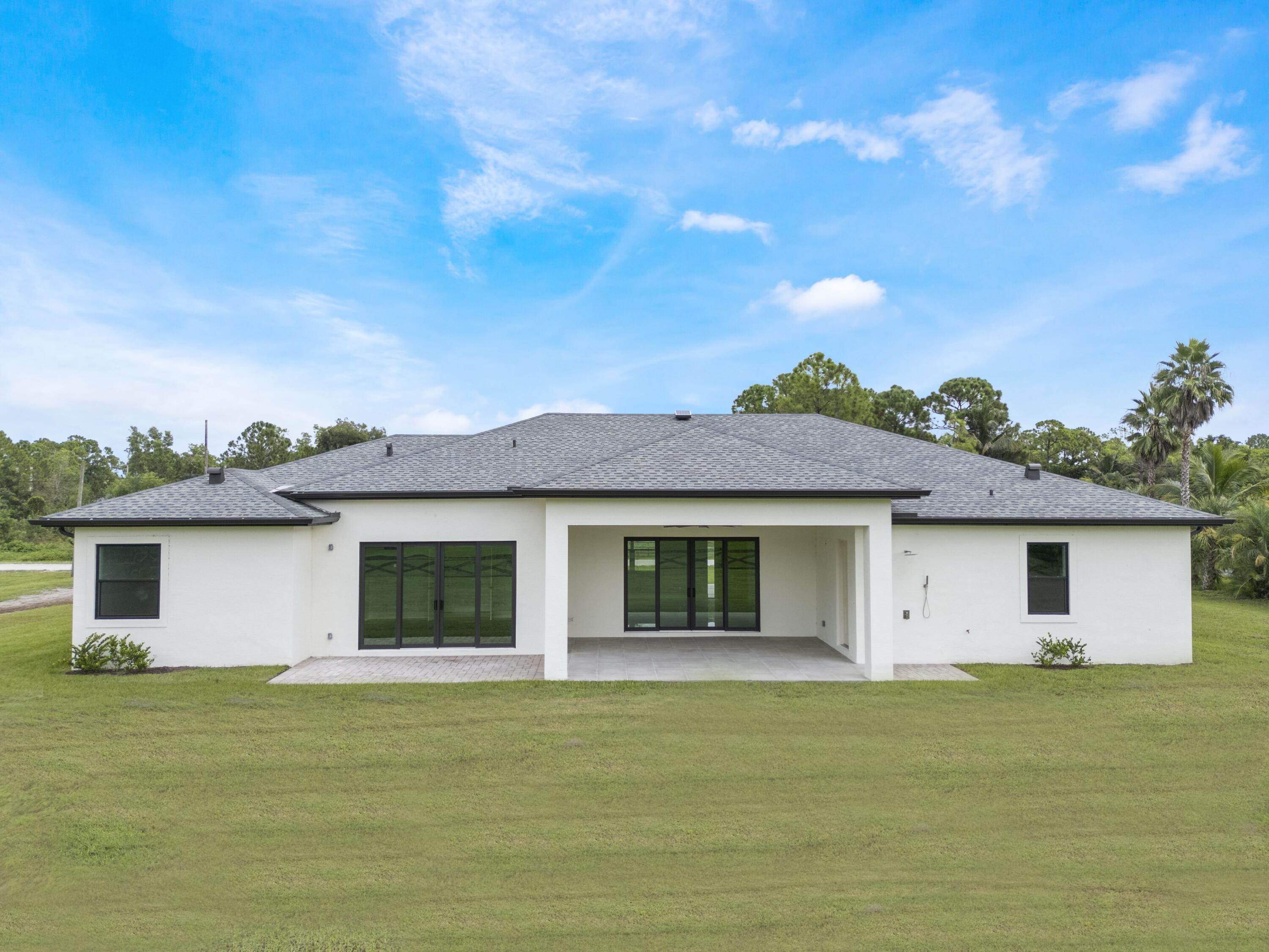 17436 71st Lane North Loxahatchee, FL 33470 - Photo 5 of 50 a front view of a house with a garden