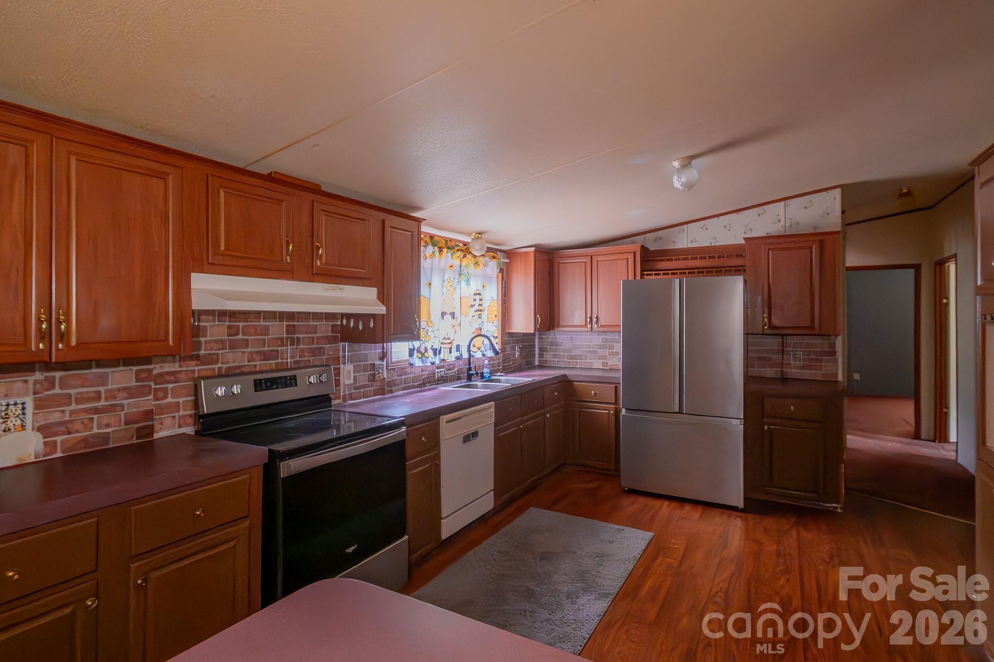 3133 Magnolia Road Bennettsville, SC 29512 - Photo 24 of 41 a kitchen with stainless steel appliances granite countertop a refrigerator stove and sink