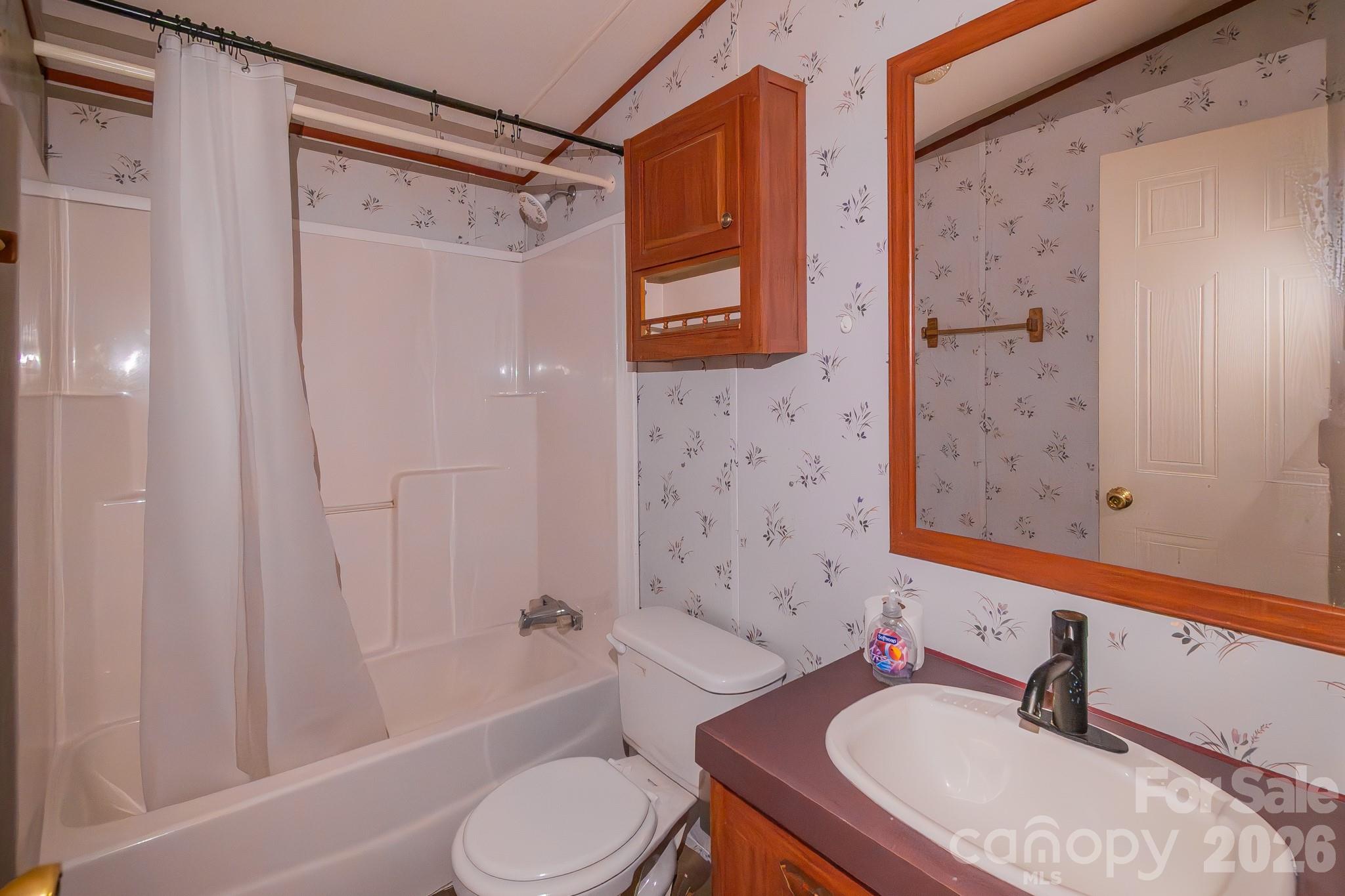 3133 Magnolia Road Bennettsville, SC 29512 - Photo 26 of 41 a bathroom with a granite countertop sink toilet and shower