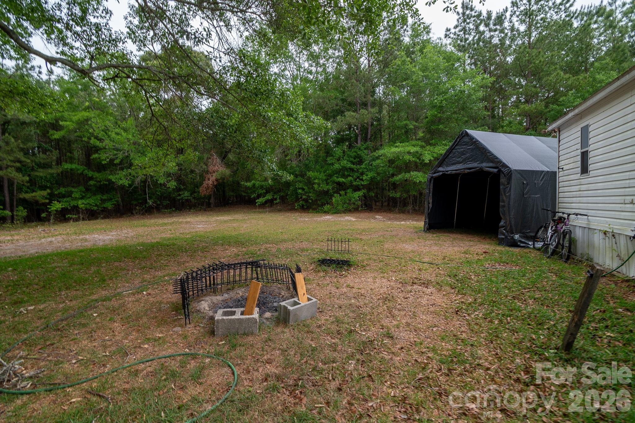 3133 Magnolia Road Bennettsville, SC 29512 - Photo 28 of 41 a backyard of a house with table and chairs