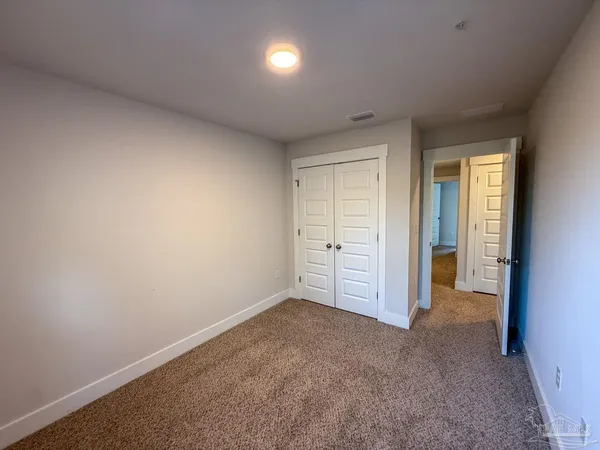 an empty room with closet area